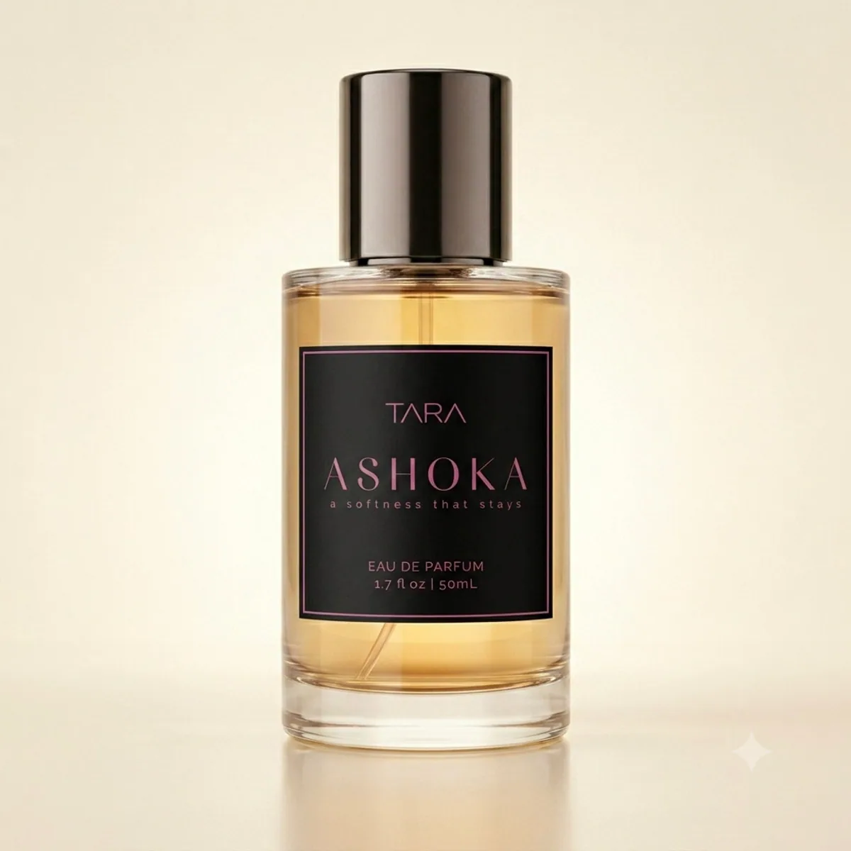 Ashoka perfume bottle with an opaque black label, golden juice, and the words a softness that stays.